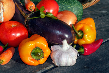 Fresh organic vegetables on a background of an old wooden table close-up.
