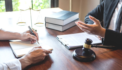 Male lawyer discussing negotiation legal case with client meeting with document contact in...