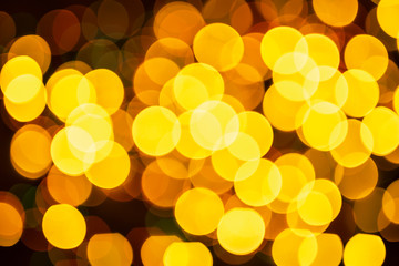 New Year pattern with bokeh lights. Christmas background with defocused yellow lights. Blurred lights.