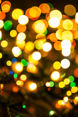 Obraz premium New Year pattern with bokeh lights. Christmas background with defocused colored lights. Blurred colourful lights.