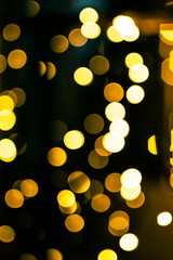 New Year pattern with bokeh lights. Christmas background with defocused yellow lights. Blurred lights.