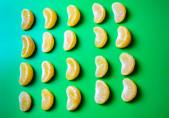 fresh sliced oranges fruit lie on a green background, top view, selective focus