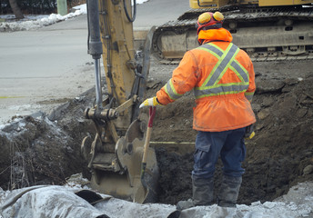 construction worker shovel road repair drain sewer work excavation digger