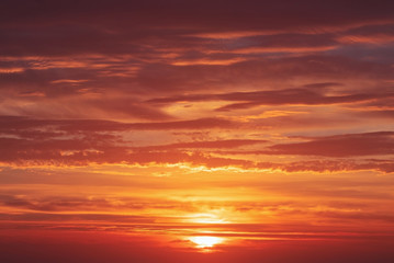 Naklejka na ściany i meble Beautiful bright sunset with multi-colored dramatic clouds