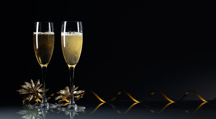 Two glasses of champagne ready to bring New Year on a black background. © Igor Normann