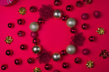 Red and gold Christmas balls on red background, top view , copy space