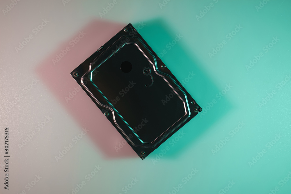 Aufkleber beautiful old hard hhd disk in the color light on a table and night background. top view.
