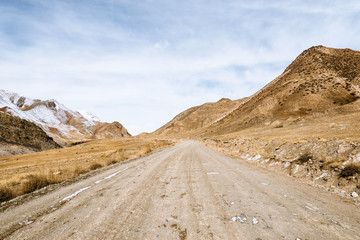 Fototapeta na wymiar the gravel road on the snow mountain
