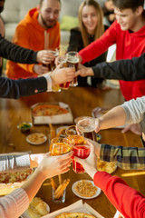 Happy co-workers celebrating while company party and corporate event. Young caucasian people in casual clothes cheering and laughting. Concept of office culture, teamwork, friendship, holidays