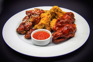 Fried chicken wings on black background
