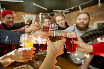 Happy co-workers celebrating while company party and corporate event. Young caucasian people in...