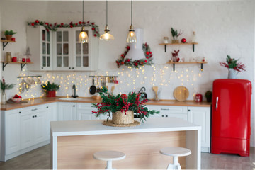 Modern Kitchen Interior with Island, Sink, Cabinets in New Luxury Home Decorated in Christmas Style.