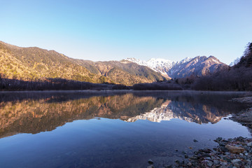 Fototapeta na wymiar Beautiful autumn season of Kamikōchi is located in the Hida Mountains,the Northern Alps of the Japan Alps. The Azusa River flows the length of the valley, filling Lake Taishō at the base of Mt. Yake. 