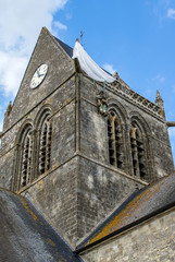 World War Two parachute memorial in honor of paratrooper John Steele on the church tower, Sainte-Mère-Église, Normandy, France
