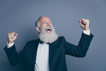Close-up portrait of his he nice attractive cheerful cheery overjoyed gray-haired man celebrating progress growth accomplishment breakthrough isolated over dark grey pastel color background