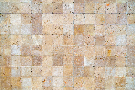 Wall Background With Yellow Natural Sandstone Tiles Stiched Together With Clay