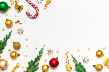 New Year Christmas composition. Frame from holiday decorations Christmas balls fir branches confetti Candy Cane on light background. Flat lay top view copy space. Winter New Year 2020 Xmas mockup