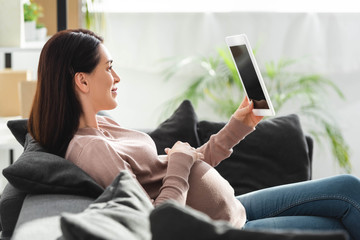 pregnant woman having online consultation with doctor on digital tablet