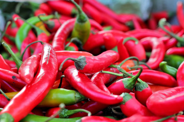 Close-up of red and green hot peppers at market stall