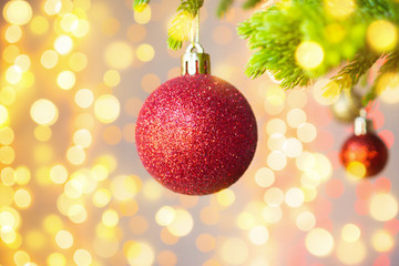Christmas tree decorated with red ball on pine branches background