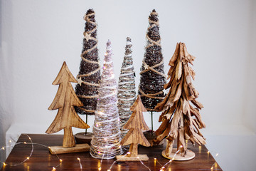 Wooden christmas trees on table.