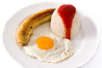 Arroz a la cubana.Typical Cuban rice with fried banana and fried egg on a plate isolated on white background