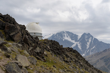 the old Observatory on the background of rocky mountains with snow. The Caucasus. Russia.