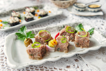 Jelly with meat, aspic beef, traditional Russian dish, portion on a plate, mustard and horseradish. Restaurant serving. Selective focus