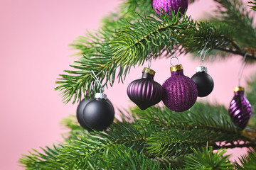 Close up of beautiful purple glass tree bauble with violet and black decorated Christmas on light...