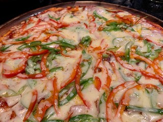 Pizza sweet pepper and cheese thin crust close up placed on the table