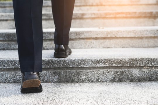 Image of a businessman walking up the stairs 