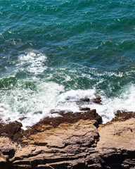 Blue waves crashing on the rocks