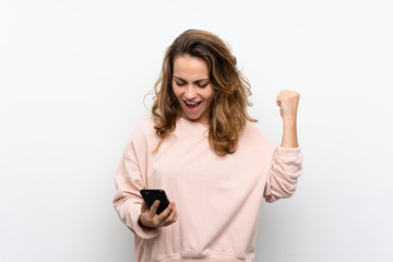 Young blonde woman using mobile phone