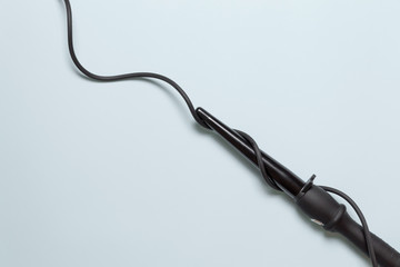 Curling irons or female hair curlers. Curls or straight hair concept