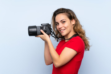 Young blonde woman with a professional camera