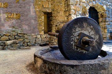 Old stones for squeezing olives oil, stone mill and mechanical press.