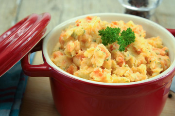 mashed carrots and potatoes on a wooden table