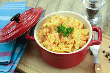 mashed carrots and potatoes on a wooden table