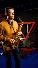 Obraz na płótnie Canvas young man playing the saxophone