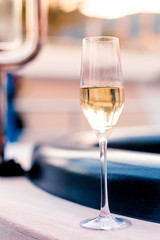 Vertical closeup shot of a champagne glass on a blurred background