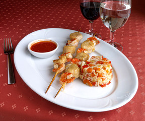 Seafood kebabs with rice and spicy sauce