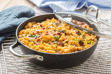 Baked pasta fusilli with smoked pork neck mozzarela cheese and othe ingredients