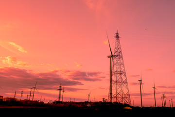 Wind turbines are generating electricity with sunset.