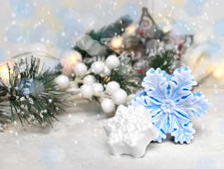 Fototapeta na wymiar Christmas toy snowflakes on bokeh festive background/ Christmas or New Year celebration concept with copyspace.