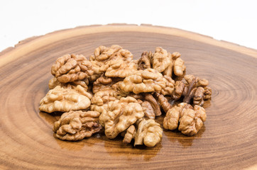 Walnut kernels on wooden slab