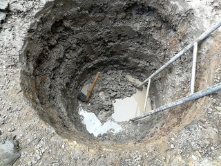 deep and big hole dig by hoe and old stair