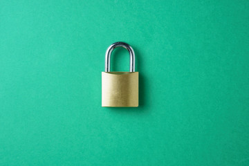 Fototapeta na wymiar Metal lock on green background