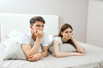couple lying on bed in living room