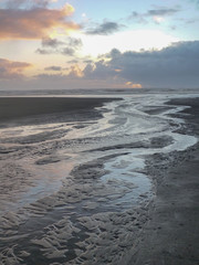 Beach scene of river flowing into ocean at Seabrook on Washington Coast