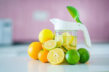 Glass jug with refreshing infused detoxification citrus water for vitamin detox drink. Slimming antioxidant drinks for diet healthy drinking
